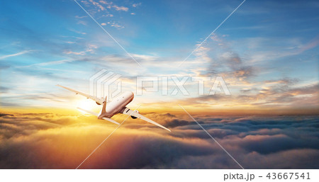 Commercial airplane flying above clouds 43667541