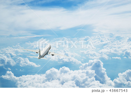 Commercial airplane flying above clouds 43667543