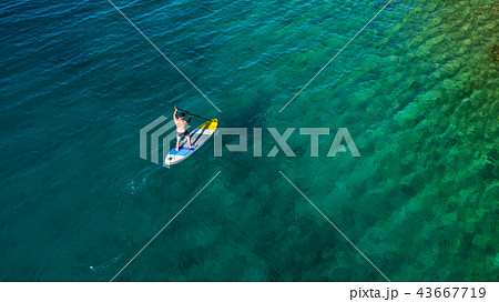 Aerial view of young man riding paddleboard 43667719