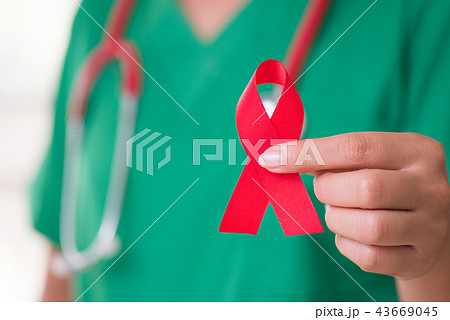 Female doctor holding red ribbon 43669045