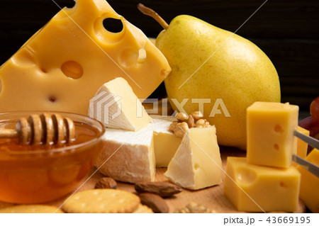 Assortment of cheeses with nuts, fruits and honey Assortment of cheeses with nuts, fruits and honey 43669195