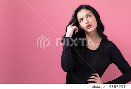 Young woman in a thoughtful pose 43670534