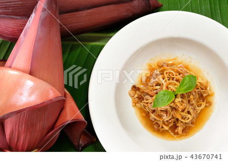 Banana blossom salad in dish on green banana leaf. Banana blossom salad in dish on green banana leaf. 43670741