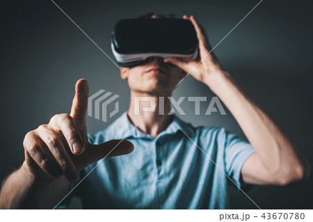 Young man with a virtual reality headset Young man with a virtual reality headset 43670780