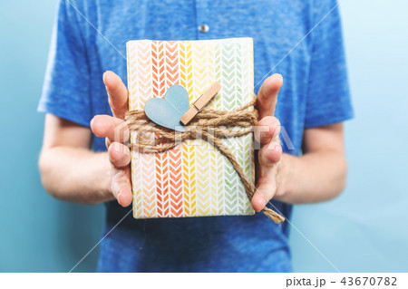 Man holding a gift box Man holding a gift box 43670782