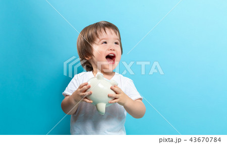 Toddler boy with a piggy bank Toddler boy with a piggy bank 43670784