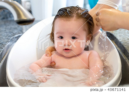 Baby boy taking a bath Baby boy taking a bath 43671141