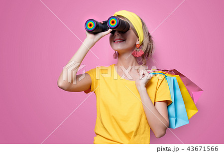 girl holding colorful bags and binoculars 43671566