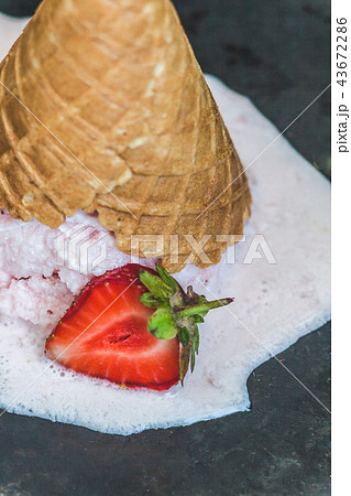 Strawberry ice cream in a waffle cone inverted and 43672286