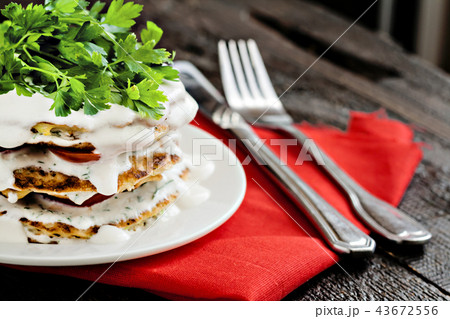 zucchini cake and eating utensils on a red napkin zucchini cake and eating utensils on a red napkin 43672556