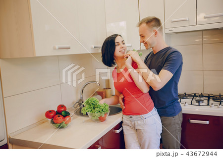 couple in a kitchen couple in a kitchen 43672944