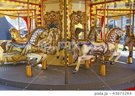 Old fashioned french carousel with horses 43673264