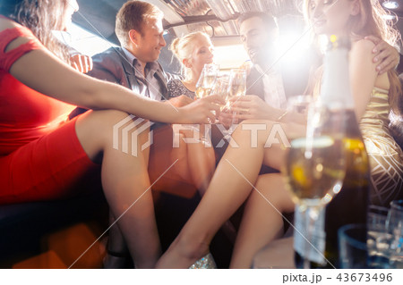 Group of party people in a limo drinking 43673496