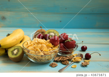Tasty cornflakes in glass bow with walnut Tasty cornflakes in glass bow with walnut 43673871