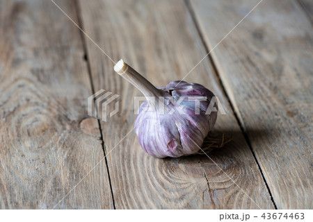 Garlic on a wooden background. Country style. Garlic on a wooden background. Country style. 43674463