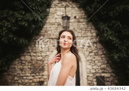 Bride. Beautiful young woman in the park with bouquet on a warm summer day. Bride. Beautiful young woman in the park with bouquet on a warm summer day. 43684342