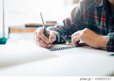 Teenage student works on homework in his room 43685557