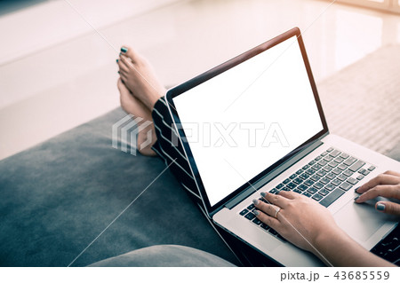 Rear view of women in a living room and laptop 43685559