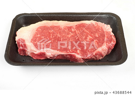 Raw beef steak in a tray isolated on white background. 43688544