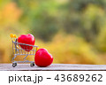 Red heart shape in mini shopping cart on wooden  43689262