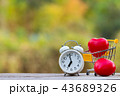 Red heart shape in shopping cart and white clock 43689326