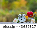 Red heart shape in shopping cart and white clock 43689327