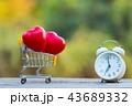 Red heart shape in shopping cart and white clock 43689332