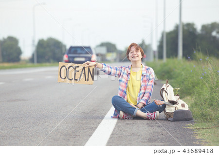 girl with a guitar hitch-hiking girl with a guitar hitch-hiking 43689418