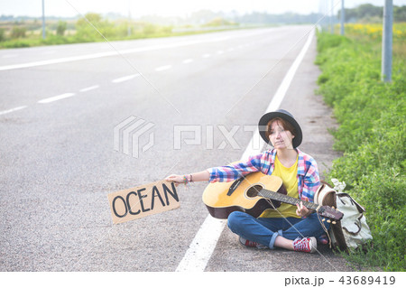 girl with a guitar hitch-hiking 43689419