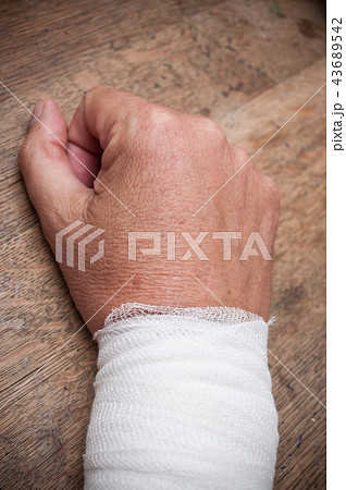 closeup of wrist sprain on wooden table 43689542