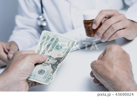 doctor man giving some pills to a senior man 43690024