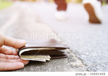Close up of hand a guy holding picking up 43691409