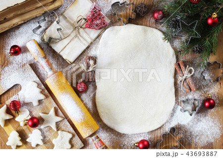 Cooking butter biscuits of different shapes on a wooden table Cooking butter biscuits of different shapes on a wooden table 43693887