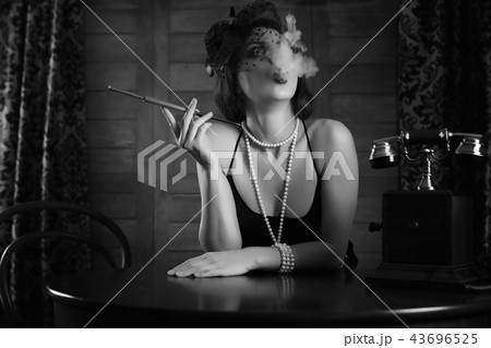 Beautiful 1930s girl smokes monochrome Beautiful 1930s girl smokes monochrome 43696525