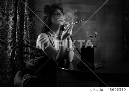 Beautiful 1930s girl smokes monochrome Beautiful 1930s girl smokes monochrome 43696530