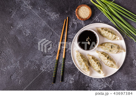 Asian dumplings, soy sauce, chopsticks, top view Asian dumplings, soy sauce, chopsticks, top view 43697384