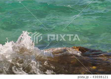 Photo of beautiful clear turquoise sea ocean water surface with ripples and bright splash on Photo of beautiful clear turquoise sea ocean water surface with ripples and bright splash on 43698121