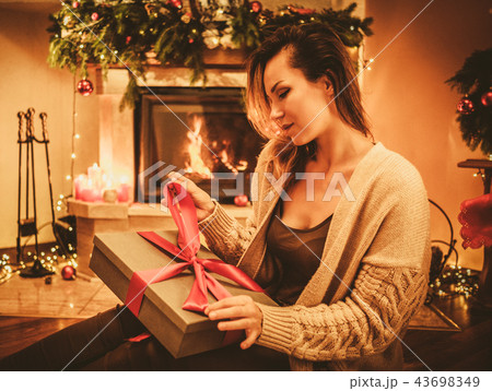 Beautiful youn woman with a Christmas gift Beautiful youn woman with a Christmas gift 43698349