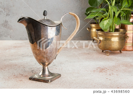 Vintage metal coffee pot and green plants Vintage metal coffee pot and green plants 43698560