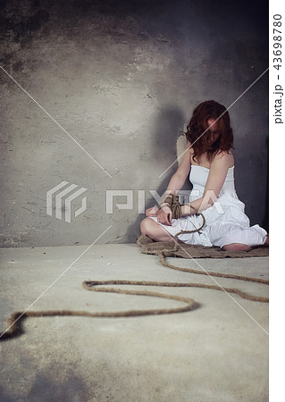 Young girl tied up on the floor
