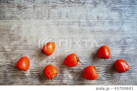 Top view of ripe persimmons on wooden table Top view of ripe persimmons on wooden table 43700681