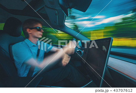 Motion blurred image a luxury vehicle driving 43707612