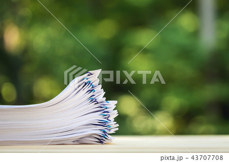 A stack of documents on forest background 43707708
