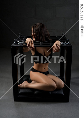 Handcuffed brunette in black lingerie in the dark 43707976