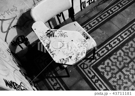 Worn school chair in black and white. 43711181