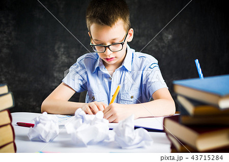 Schoolboy finishing homework at home 43715284