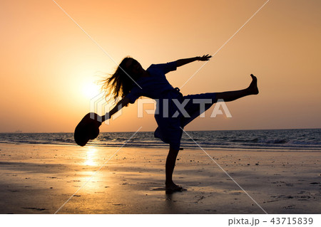 Girl on the beach at sunset Girl on the beach at sunset 43715839