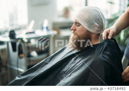 Male client getting haircut by hairdresser in barber shop Male client getting haircut by hairdresser in barber shop 43716492