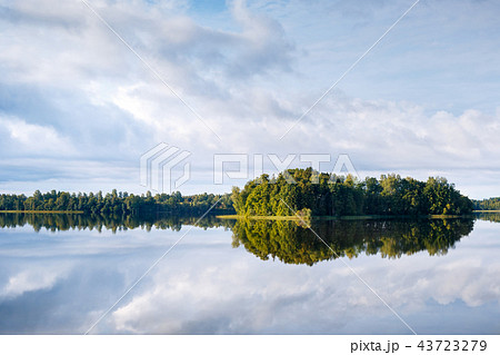 A lake, perfect reflection, clouds, and forest A lake, perfect reflection, clouds, and forest 43723279