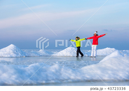 Young mother and her son on icy beach 43723336
